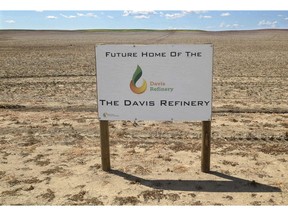 FILE - This July 19, 2018, file photo shows a sign on property, near southwest Belfield, N.D., for the future home of the Davis Refinery near Theodore Roosevelt National Park. An administrative law judge in North Dakota is recommending that state officials issue a water permit for an oil refinery being developed near Theodore Roosevelt National Park. Area landowners challenged a proposed permit that would allow the Davis Refinery to draw water from an underwater aquifer.