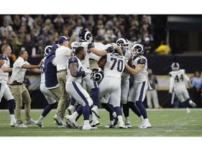 Los Angeles Rams celebrate after overtime of the NFL football NFC championship game against the New Orleans Saints, Sunday, Jan. 20, 2019, in New Orleans. The Rams won 26-23.
