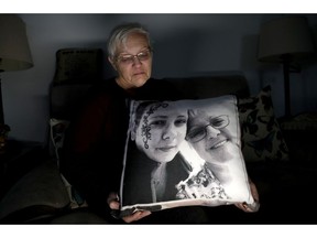 In a photo taken Friday, Jan. 18, 2019, Deborah Fuller poses for a photograph for The Associated Press with a pillow showing a photo of her late daughter, Sarah Fuller, left, who passed of a prescription drug overdose, and her during an interview in her home in West Berlin, N.J. The trial of a Insys Therapeutics Inc. founder John Kapoor, who accused of scheming to bribe doctors into prescribing a powerful painkiller, is putting a spotlight on the nation's deadly opioid crisis.