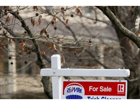 FILE - In this Jan. 3, 2019, file photo a realtor sign marks a home for sale in Franklin Park, Pa.  The partial federal government shutdown is complicating the already complicated process of getting and managing a mortgage. For one thing, the political storm is like severe weather at a major airport: You can expect minor delays or worse. Also, it could mean financial hardship for some federal government employees facing mortgage payments without their regular paychecks.