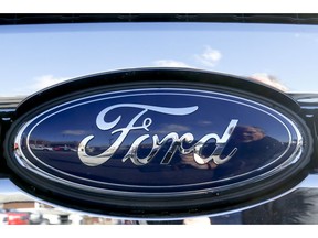 FILE - This Nov. 19, 2015 file photo shows the blue Ford oval badge in the grill of a pickup truck on the sales lot at Butler County Ford in Butler, Pa.  On Friday, Jan. 4, 2019, Ford is recalling more than 953,000 vehicles worldwide to replace Takata passenger air bag inflators that can explode and hurl shrapnel. The move includes 782,000 vehicles in the U.S. and is part of the largest series of recalls in U.S. history.