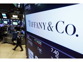 FILE - In this Nov. 28, 2018 file photo, the logo for Tiffany & Co. appears above a post on the floor of the New York Stock Exchange. The luxury jeweler, famous for its little blue boxes, says sales slipped in the holiday shopping season as Chinese tourists spent less while traveling due to the strong dollar, making it more expensive to buy Tiffany jewelry outside of its stores in China. The company also says it was hurt by the ups and downs of the stock market, anxiety around Brexit and protests in Paris that forced the company to close its store during some weekends.
