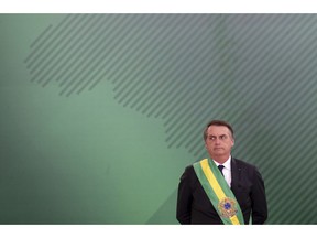 FILE - In this Jan. 1, 2019, file photo, Brazil's President Jair Bolsonaro looks on as he presents his cabinet at the Planalto Presidential palace, in Brasilia, Brazil. The far-right leader's first two weeks on the job have been filled with missteps and communication gaffes and little of his promised sweeping changes, underscoring a steep learning curve for a president elected on promises to overhaul much of daily life in Latin America's largest nation.