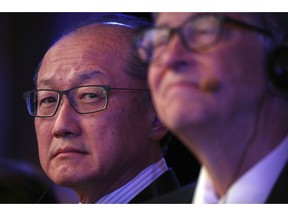 FILE- In this Nov. 6, 2018, file photo World Bank President Jim Yong Kim, left, and Bill Gates, former Microsoft CEO and co-founder of the Bill and Melinda Gates Foundation, listen to a speaker at the Reinvented Toilet Expo in Beijing. Kim, the president of the World Bank, says he is resigning at the end of January. Kim's unexpected departure nearly three years before his term was set to expire, is likely to set off a fierce battle between the Trump administration and other countries who have complained about the influence the United States exerts over the World Bank.