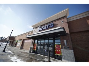 FILE- In this Tuesday, Jan. 1, 2019, file photo signs mark the closing of a Sears store in the Streets of Southglenn mall in Littleton, Colo. Sears is getting another reprieve from liquidation after its chairman and largest shareholder revised his bid to save the iconic brand. The Hoffman Estates, Illinois-based retailer says it has accepted Eddie Lampert's bid through an affiliate of his ESL hedge fund that could keep 425 stores open and save tens of thousands of workers, according to a hearing on Tuesday, Jan. 8, 2019, at the bankruptcy court in White Plains, N.Y.