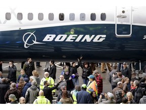 FILE- In this Feb. 5, 2018, file photo a Boeing 737 MAX 7, the newest version of Boeing's fastest-selling airplane, is displayed during a debut for employees and media of the new jet in Renton, Wash. The Boeing Company reports earnings Wednesday, Jan. 30, 2019.