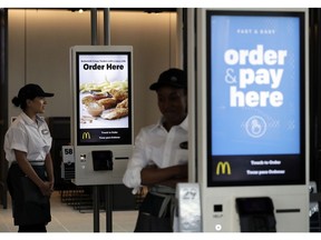 FILE- In this Aug. 8, 2018, file photo employees stand in McDonald's Chicago flagship restaurant. McDonald's reports earnings Wednesday, Jan. 30, 2019.