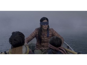 FILE- This file image released by Netflix shows Sandra Bullock in a scene from the film, "Bird Box." Netflix lifted the usually tightly sealed lid on its viewership numbers in a recent tweet that disclosed 45 million subscriber accounts had watched the thriller, "Bird Box," during its first seven days on the service. That made the film the biggest first-week success of any movie made so far for Netflix's 12-year-old streaming service.