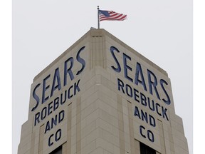 FILE- In this Jan. 8, 2019, file photo an American flag flies above a Sears store in Hackensack, N.J. Sears confirmed Thursday, Jan. 17, that chairman and largest shareholder Eddie Lampert's hedge fund has won tentative approval for a $5.2 billion plan to buy 425 stores and the rest of its assets.