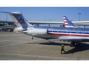FILE- In this Nov. 5, 2018, file photo American Airlines aircraft are serviced at Dallas/Fort Worth International Airport, in Texas. American Airlines reports financial results Thursday, Jan. 24, 2019.