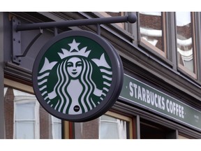 FILE- This Dec. 13, 2018, file photo shows a sign for a Starbucks Coffee shop in Harvard Square in Cambridge, Mass. Starbucks Corp. reports financial results Thursday, Jan. 24, 2019.