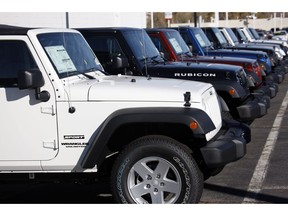 FILE- In this Nov. 1, 2009, file photo unsold 2010 Wranglers sit at a Chrysler/Jeep dealership in Englewood, Colo. Fiat Chrysler is recalling more than 1.6 million vehicles worldwide to replace Takata front passenger air bag inflators that can be dangerous. The recall covers the 2010 through 2016 Jeep Wrangler SUV, the 2010 Ram 3500 pickup and 4500/5500 Chassis Cab trucks, the 2010 and 2011 Dodge Dakota pickup, the 2010 through 2014 Dodge Challenger muscle car, the 2011 through 2015 Dodge Charger sedan, and the 2010 through 2015 Chrysler 300 sedan.