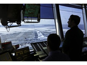 FILE - In this March 16, 2017, file photo, air traffic controllers work in the tower at John F. Kennedy International Airport in New York. The partial government shutdown is starting to effect air travelers. Over the weekend, some airports had long lines at checkpoints, apparently caused by a rising number of security officers calling in sick while they are not getting paid.