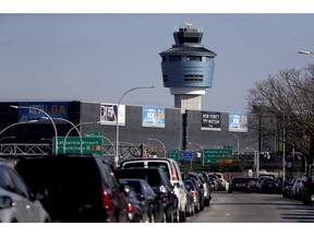 The air traffic control tower at LaGuardia Airport is seen, Friday, Jan. 25, 2019, in New York. The Federal Aviation Administration reported delays in air travel Friday because of a "slight increase in sick leave" at two East Coast air traffic control facilities.