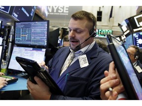 FILE- In this Jan. 18, 2019, file photo trader Michael Milano works on the floor of the New York Stock Exchange. The U.S. stock market opens at 9:30 a.m. EST on Wednesday, Jan. 23.