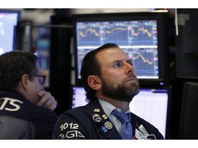 FILE- In this Jan. 3, 2019, file photo specialist Michael Pistillo, right, works on the floor of the New York Stock Exchange. The U.S. stock market opens at 9:30 a.m. EST on Wednesday, Jan. 9.