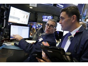 FILE- In this Jan. 3, 2019, file photo specialist Anthony Rinaldi, left, works at his post on the floor of the New York Stock Exchange. The U.S. stock market opens at 9:30 a.m. EST on Thursday, Jan. 10.