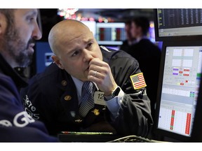 FILE- In this Wednesday Jan. 2, 2019, photo specialist Mario Picone, center, works on the floor of the New York Stock Exchange. The U.S. stock market opens at 9:30 a.m. EST on Thursday, Jan. 3.