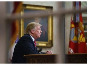 FILE- In this Tuesday, Jan. 8, 2019, file photo seen from a window outside the Oval Office, President Donald Trump gives a prime-time address about border security at the White House in Washington. With the standoff over paying for his long-promised border wall dragging on, the president's Oval Office address and visit to the Texas border over the past week failed to break the logjam and left aides and allies fearful that the president has misjudged Democratic resolve and is running out of negotiating options.