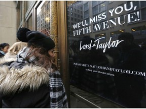 Women peer in the front door of Lord & Taylor's flagship Fifth Avenue store which closed for good, Wednesday, Jan. 2, 2019, in New York. After 104 years, the104-year old retail store locked its doors forever. The venerable department store famed for its animated holiday windows ended a blowout sale mid-afternoon Wednesday that left whole floors empty. By the end, clothes that once sold for as much as $100 were going for $5.99.