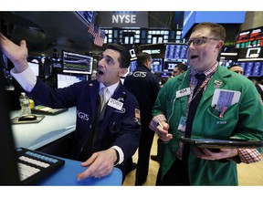 Specialist Peter Mazza, left, and trader Ryan Falvey work on the floor of the New York Stock Exchange, Thursday, Jan. 10, 2019. Stocks are slumping in early trading on Wall Street led by steep drops in Macy's and other retailers after several of the companies reported weak holiday sales.