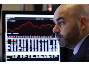 Trader Fred DeMarco works in a booth on the floor of the New York Stock Exchange, Wednesday, Jan. 2, 2019. Stock markets started the new year with a tumble, as disappointing Chinese economic data on Wednesday renewed concerns that a global trade war is weighing on growth.