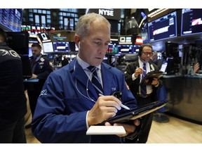 Trader Timothy Nick, center, works on the floor of the New York Stock Exchange, Monday, Jan. 28, 2019. Stocks are opening broadly lower on Wall Street as traders worry about the impact on U.S. companies of a slowdown in China's economy.