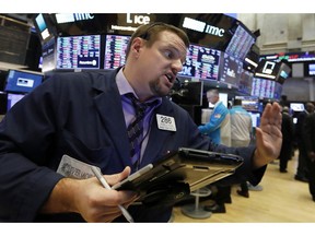 FILE - In a Thursday, Jan. 3, 2019 file photo, trader Michael Milano works on the floor of the New York Stock Exchange. One recent characteristic of the stock market is that every day can feel like bedlam. Investors have been careening from fear to relief and back again depending on the latest news. More tests of the market's mettle lie ahead, with U.S.-China trade talks, the fourth-quarter earnings period and another Federal Reserve meeting on the horizon.