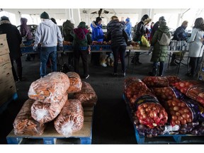 Philabundance volunteers distribute food to furloughed federal workers and their families who are affected by the partial government shutdown, under Interstate 95 in Philadelphia, Wednesday, Jan. 23, 2019.