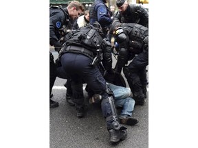 Police detain a demonstrator in Souillac, southern France, as police block the access to the congress hall ahead of French President Emmanuel Macron' s visit, Friday, Jan. 18, 2019. Macron is meeting Friday with about 600 mayors and local officials in Souillac, a small town in southwestern France, as part of a national "grand debate".