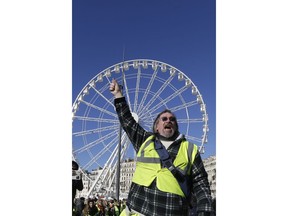 A yellow vest protester demonstrates peacefully in downtown Marseille, southern France, Saturday, Jan. 12, 2019. Authorities deployed 80,000 security forces nationwide for a ninth straight weekend of anti-government protests.