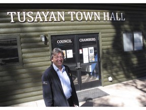 FILE - In this Nov. 1, 2017, file photo, Tusayan Mayor Craig Sanderson stands outside the town's office in Tusayan, Ariz. An off-grid housing project in a tiny town outside the Grand Canyon has come to a halt over a flood plain permit. Millions of tourists pass through Tusayan every year unaware of the decades of infighting over housing.