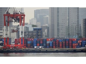 In this June 18, 2018, photo, containers are piled up to be exported at a port in Tokyo. Japanese government data show the nation's exports fell 3.8 percent in December, compared to a year ago, pushed down by falling exports to China, according to Ministry of Finance data released Wednesday, Jan. 23, 2019.