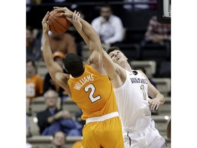 Tennessee forward Grant Williams (2) and Vanderbilt forward Yanni Wetzell (1) reach for the ball during the first half of an NCAA college basketball game Wednesday, Jan. 23, 2019, in Nashville, Tenn.