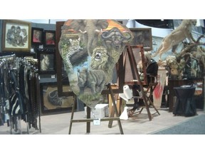 This image provided by the Humane Society of the United States shows a painting on elephant hide for sale at the Safari Club International conference in Reno, Nev., on Jan. 9, 2019. Photos and video taken by animal welfare activists show an array of potentially illicit products crafted from the body parts of threatened big-game animals, including boots, chaps, belts and furniture labeled as elephant leather. The artist told the activists on a video they recorded that the painting was on elephant hide. (Humane Society of the United States via AP)