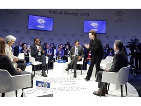 Singer and co-founder of RED Bono, 2nd right, gestures to Afsaneh Mashayekhi Beschloss, founder of RockCreek, Christine Lagarde, Managing Director of IMF and Rwanda President Paul Kagame, from left, as he arrives for the "Closing the Financing Gap" session at the annual meeting of the World Economic Forum in Davos, Switzerland, Wednesday, Jan. 23, 2019.