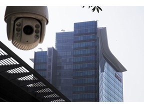 In this Dec. 18, 2018, photo, a surveillance camera is mounted near the Huawei headquarters in Shenzhen in south China's Guangdong province. The U.S. Justice Department unsealed criminal charges Monday, Jan. 28, 2019 against Chinese tech giant Huawei, a top company executive and several subsidiaries, alleging the company stole trade secrets, misled banks about its business and violated U.S. sanctions.