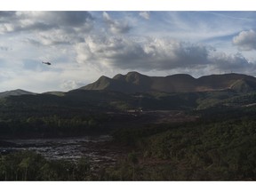 Members of the rescue operation fly over the site where a dam collapsed two days ago, next to dam B6 that also had an collapse alert, in Brumadinho, Brazil, Sunday, Jan. 27, 2019. Authorities evacuated several neighborhoods in the southeastern city of Brumadinho that were within range of the B6 dam owned by the Brazilian mining company Vale.