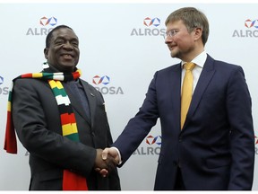 Zimbabwe's President Emmerson Dambudzo Mnangagwa, left, and CEO of of the Alrosa diamond mining company Sergey Ivanov shake hands during their meeting in Moscow, Russia, Monday, Jan. 14, 2019. Zimbabwe's President Emmerson Dambudzo Mnangagwa will meet Russian President Vladimir Putin on Tuesday.