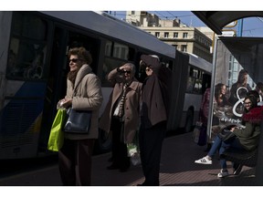 People wait at a bus station in central Athens, on Monday, Jan. 28, 2019. Greece announced plans to issue a 5-year bond, in the first market test since the end of its international Bailout last August.