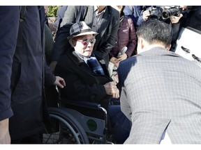 FILE - In this Oct. 30, 2018, file photo, South Korean Lee Chun-sik, 94-year-old victim of forced labor during Japan's colonial rule of the Korean Peninsula before the end of World War II, sits on a wheelchair upon his arrival at the Supreme Court in Seoul, South Korea. Lawyers for South Koreans forced into wartime labor have taken legal steps to seize the South Korean assets of a Japanese company they are trying to pressure into following a court ruling to provide them compensation.