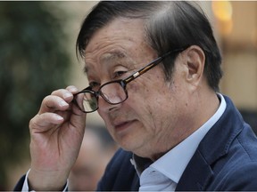 Ren Zhengfei, founder and CEO of Huawei, adjusts his glasses during a round table meeting with the media in Shenzhen city, south China's Guangdong province, Tuesday, Jan. 15, 2019. The founder of network gear and smart phone supplier Huawei Technologies said the tech giant would reject requests from the Chinese government to disclose confidential information about its customers.