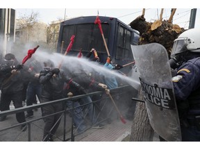 Policemen use tear gas against protesters during a rally outside the parliament in Athens, Monday, Jan. 14, 2019. Greek riot police have used tear gas to disperse rioting state schoolteachers, days after the country's public order minister criticized officers for allegedly using "indiscriminate" violence against protesting schoolteachers in similar circumstances.