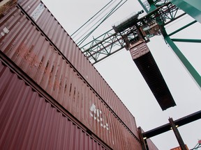 A crane takes a freight container from a ship in Halifax.