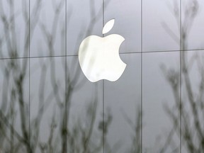 The Apple Inc. logo is displayed at the company's store at Sanlitun in Beijing, China. Apple cut its revenue outlook for the first time in almost two decades citing weaker demand in China.