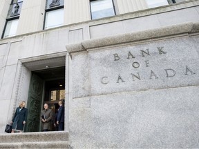 Carolyn Wilkins, senior deputy governor of the Bank of Canada, left, and Stephen Poloz, governor of the Bank of Canada, leave the Bank of Canada building for a press conference in Ottawa.