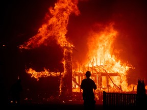 A home burns as the Camp Fire rages through Paradise, Calif. last November.
