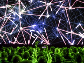 An attendee takes a photograph of the stage prior to the Nvidia Corp. event at the 2018 Consumer Electronics Show (CES) in Las Vegas on Sunday, Jan. 6, 2019. CES showcases more than 4,500 exhibiting companies, including manufacturers, developers and suppliers of consumer technology hardware, content, technology delivery systems and more.