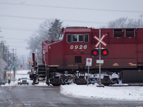 A Canadian Pacific Railway train passes through a crossing on a rural road in Delta, B.C.