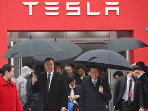 Tesla CEO Elon Musk, left, walks with Shanghai Mayor Ying Yong during the ground-breaking ceremony for a Tesla factory in Shanghai on January 7, 2019.